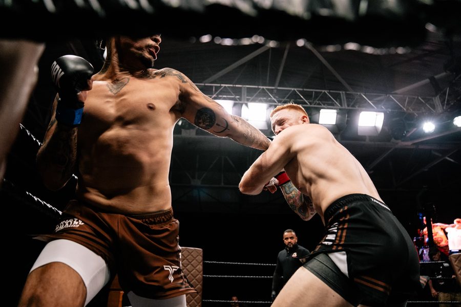 Jansey Silva trades strikes with an opponent in the cage.